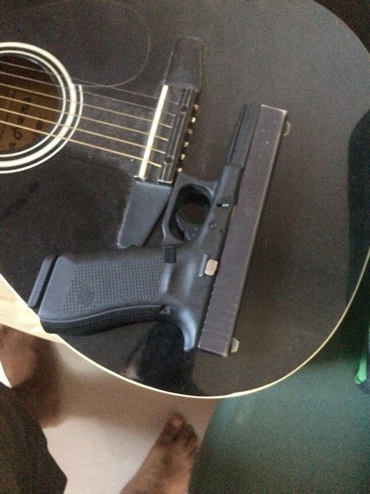 glock 17 gen 4 side view on hand with loaded mag…e near guitar.jpeg