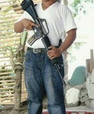 m16 rifle side view carried by a man in white shirt.jpeg
